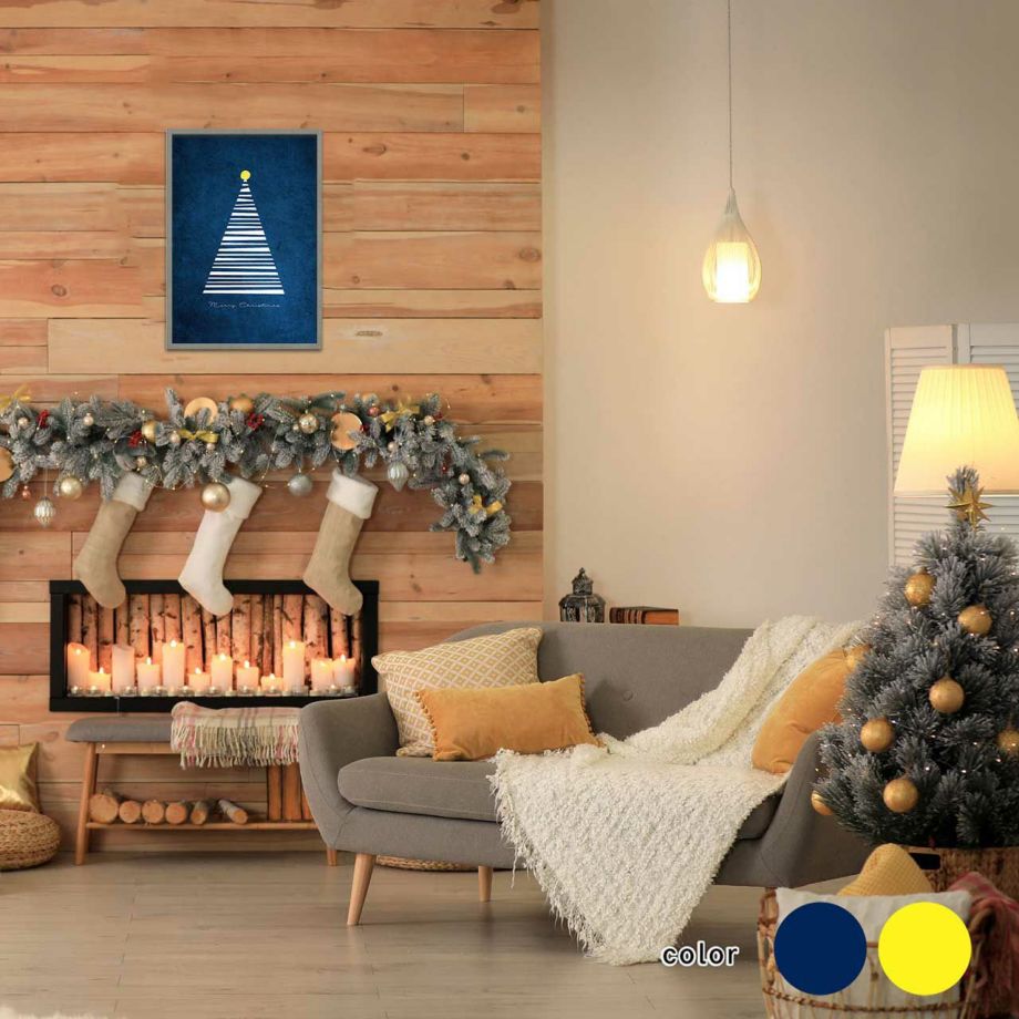 青色背景にホワイトのクリスマスツリーが描かれたポスターがある部屋