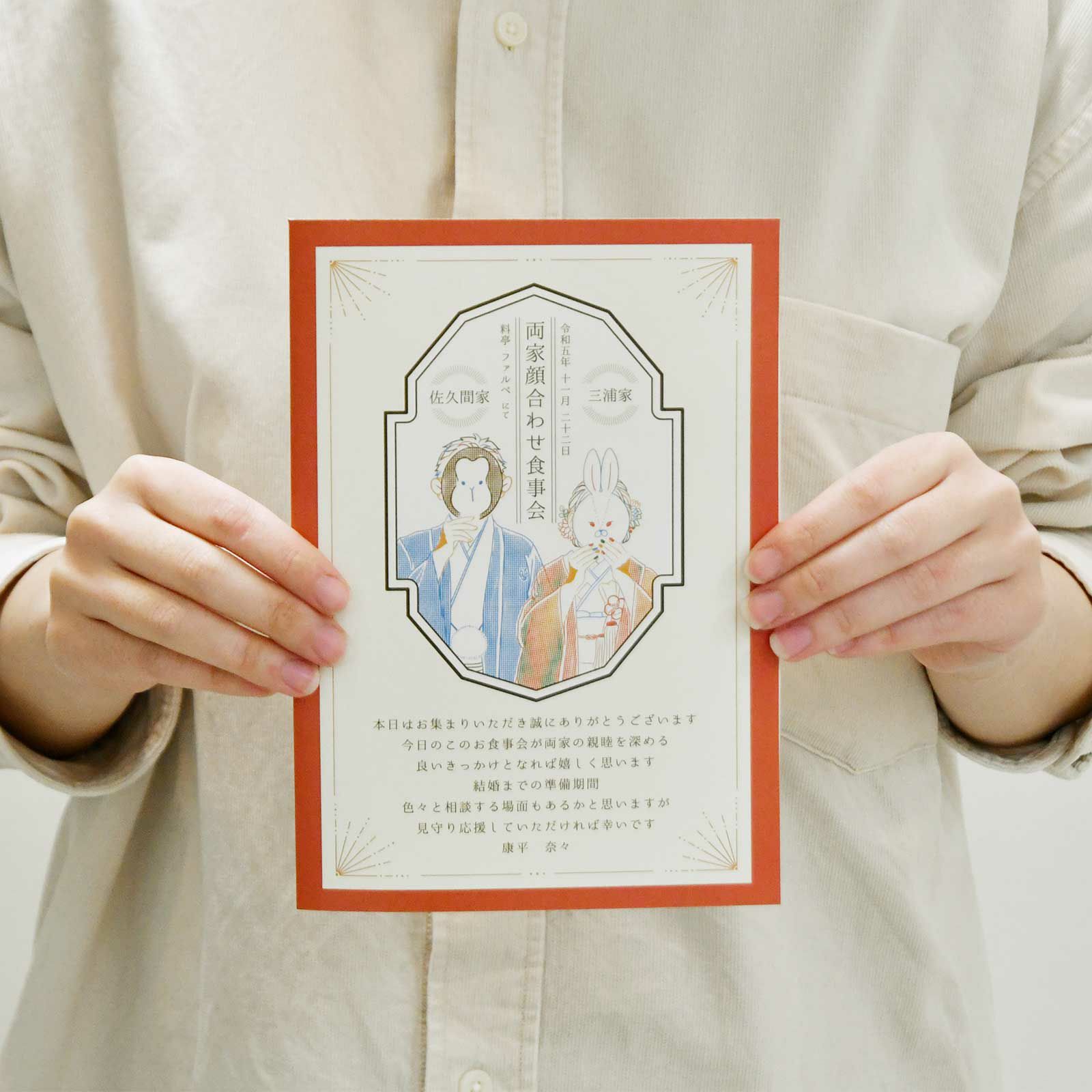 顔合わせ会しおりを手に持っている